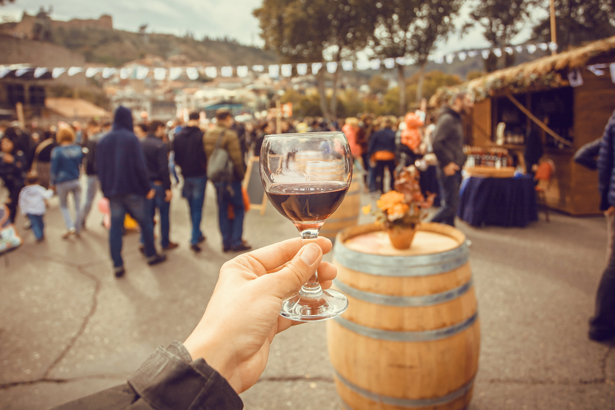 Holding A Glass At Wine Festival 1200X800